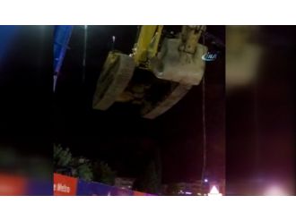 İş makinesini vinçle trafiğin üzerinden geçirdiler