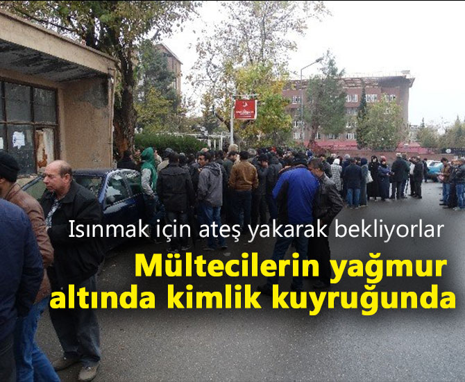 Mültecilerin yağmur altında kimlik kuyruğunda