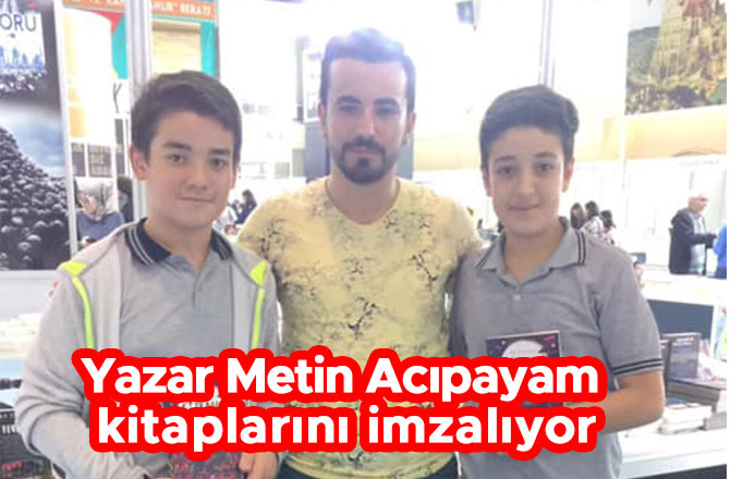 Yazar Metin Acıpayam kitaplarını imzalıyor