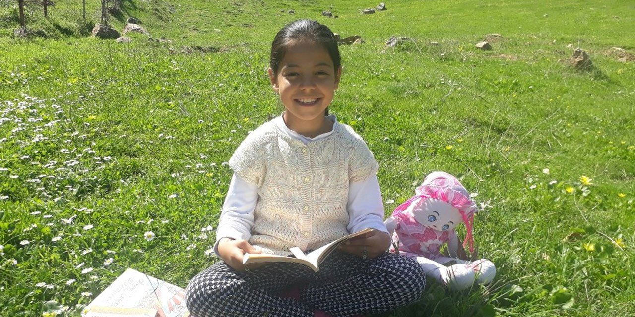 9. Yaşında ki öğrenci bahçelerinde kitap okuyarak karantina günlerini geçiriyor